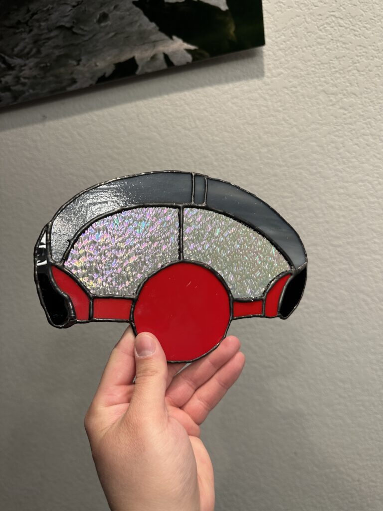 stained glass ball gag with a gray headband and bright red ball gag.