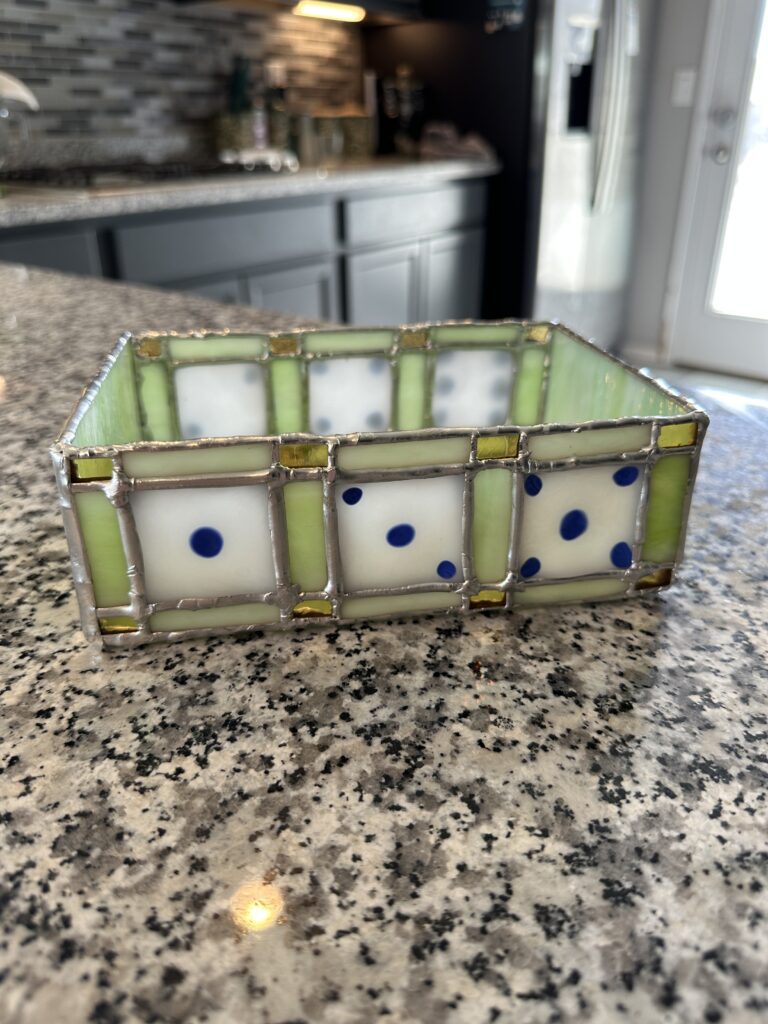 Light green tray. You can see 3 dice faces on either side.