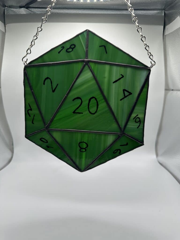 Streaky green D20 showing the 20 side up.