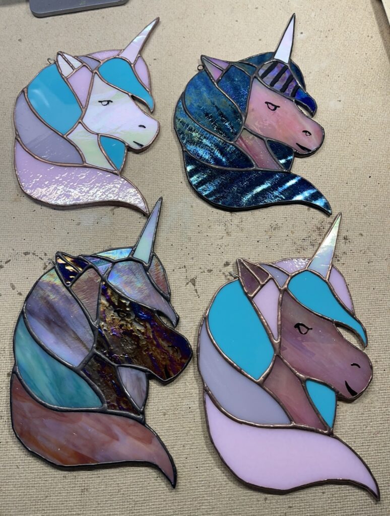 4 different colored glass unicorns